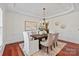 Bright dining room featuring elegant chandelier, wainscoting, and coffered ceiling at 10104 Silverling Dr, Waxhaw, NC 28173