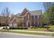 Charming two-story red brick home with a manicured lawn and beautiful landscaping at 10104 Silverling Dr, Waxhaw, NC 28173