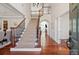 Elegant foyer with a grand staircase, hardwood floors, and abundant natural light at 10104 Silverling Dr, Waxhaw, NC 28173