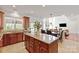 Open-concept kitchen featuring granite countertops, stainless steel appliances, and seamless flow to the dining and living areas at 10104 Silverling Dr, Waxhaw, NC 28173
