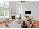 Bright living room with high ceilings, fireplace, large windows, and neutral decor at 10104 Silverling Dr, Waxhaw, NC 28173