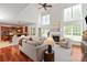 Spacious living room with a fireplace, large windows, and an open floor plan at 10104 Silverling Dr, Waxhaw, NC 28173