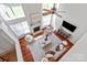 Open concept living room with high ceilings, a fireplace, large windows, and hardwood floors at 10104 Silverling Dr, Waxhaw, NC 28173