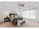 Bright main bedroom with a tray ceiling, large windows, and stylish decor at 10104 Silverling Dr, Waxhaw, NC 28173