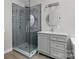 Stylish bathroom with glass-enclosed shower, gray vanity, and modern fixtures at 1014 Sandbox Cir, Indian Trail, NC 28079