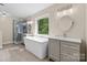 Bathroom featuring a free-standing tub, updated vanity, a glass enclosed shower, and large window at 1014 Sandbox Cir, Indian Trail, NC 28079
