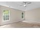Bright bedroom with tray ceiling, ceiling fan, and two windows allowing lots of natural light at 1014 Sandbox Cir, Indian Trail, NC 28079