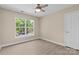 Well lit bedroom with a ceiling fan, and view from the window at 1014 Sandbox Cir, Indian Trail, NC 28079
