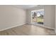 Bright bedroom with large windows, neutral paint, and light wood floors at 1014 Sandbox Cir, Indian Trail, NC 28079
