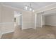Dining room with modern chandelier, wainscoting, and an open layout at 1014 Sandbox Cir, Indian Trail, NC 28079