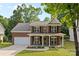 Charming two-story brick home featuring a welcoming front porch and well-manicured lawn at 1014 Sandbox Cir, Indian Trail, NC 28079