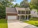 Beautiful two-story brick home with a covered front porch and a spacious driveway at 1014 Sandbox Cir, Indian Trail, NC 28079