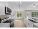 Bright kitchen features stainless steel appliances and white cabinetry at 1014 Sandbox Cir, Indian Trail, NC 28079