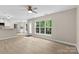 A spacious living area with wood-look flooring and a view to the kitchen at 1014 Sandbox Cir, Indian Trail, NC 28079