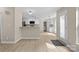 Open floor plan with kitchen, living, and dining areas with wood-look floors at 1014 Sandbox Cir, Indian Trail, NC 28079