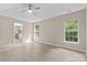 Spacious main bedroom with light colored walls, ceiling fan, and wood-look floors at 1014 Sandbox Cir, Indian Trail, NC 28079