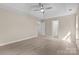 Spacious main bedroom with light colored walls, ceiling fan, and wood-look floors at 1014 Sandbox Cir, Indian Trail, NC 28079