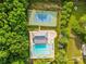 A high angle view of a community pool, tennis court, jacuzzi, and surrounding greenery at 1014 Sandbox Cir, Indian Trail, NC 28079
