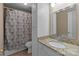 Bathroom with vanity and toilet, shower with decorative curtain, and tile floors at 1109 E Morehead St # 22, Charlotte, NC 28204