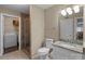 Bathroom featuring granite vanity, toilet, large mirror, and glass shower with laundry room access at 1109 E Morehead St # 22, Charlotte, NC 28204