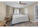 Bright bedroom with hardwood floors, ceiling fan, and a large window with blinds at 1109 E Morehead St # 22, Charlotte, NC 28204