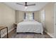 Bedroom featuring hardwood floors, ceiling fan, and a large window with blinds at 1109 E Morehead St # 22, Charlotte, NC 28204