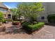 Serene courtyard with lush greenery, hedges, brick pathways, and shade trees at 1109 E Morehead St # 22, Charlotte, NC 28204