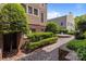 Beautifully landscaped courtyard with a fountain, hedges, and brick walkways at 1109 E Morehead St # 22, Charlotte, NC 28204
