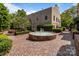 Charming courtyard featuring a round fountain, manicured hedges, and brick paving at 1109 E Morehead St # 22, Charlotte, NC 28204