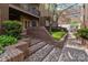 Exterior view of a condo entrance with brick stairs and mature landscaping at 1109 E Morehead St # 22, Charlotte, NC 28204