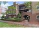 Attractive condo with brick entryway, wood siding, and well-maintained landscaping at 1109 E Morehead St # 22, Charlotte, NC 28204