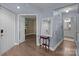 Hallway featuring hardwood floors, small decorative table, and entrance to bathroom and living spaces at 1109 E Morehead St # 22, Charlotte, NC 28204