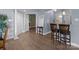 Living room with hardwood floors, bar seating, and neutral paint scheme at 1109 E Morehead St # 22, Charlotte, NC 28204