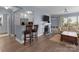 Open-concept living space showcasing a kitchen bar, fireplace, hardwood flooring, and cozy seating at 1109 E Morehead St # 22, Charlotte, NC 28204