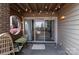 Relaxing brick patio with string lights, round window, and sliding glass doors at 1109 E Morehead St # 22, Charlotte, NC 28204