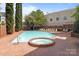Community pool with a hot tub, plenty of lounging area, and manicured landscaping at 1109 E Morehead St # 22, Charlotte, NC 28204