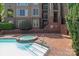 A stylish community pool and hot tub area with brick paving and condo building backdrop at 1109 E Morehead St # 22, Charlotte, NC 28204
