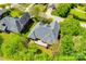 Aerial view of a home's backyard, showing a deck and mature trees surrounding the property at 1126 Blowing Rock Cv, Fort Mill, SC 29708