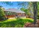 Backyard of brick home with large deck and lush lawn at 1126 Blowing Rock Cv, Fort Mill, SC 29708