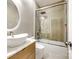 Modern bathroom with a vessel sink, sleek vanity, and a glass-enclosed shower over tub at 1126 Blowing Rock Cv, Fort Mill, SC 29708