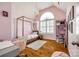 Cozy pink bedroom featuring a four-poster bed, a window with shutters, and stylish decor at 1126 Blowing Rock Cv, Fort Mill, SC 29708