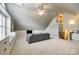 Spacious bonus room features built-in shelving and a comfortable sofa at 1126 Blowing Rock Cv, Fort Mill, SC 29708