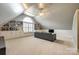 Bonus room with large arched window, built-in shelves, and comfortable couch at 1126 Blowing Rock Cv, Fort Mill, SC 29708