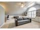 Spacious bonus room with large arched window, built-in shelves, and a cozy couch at 1126 Blowing Rock Cv, Fort Mill, SC 29708