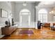 Elegant foyer with high ceilings, arched windows, hardwood floors, and stylish decor at 1126 Blowing Rock Cv, Fort Mill, SC 29708