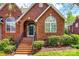 Close-up of brick home's entry featuring a brick staircase leading to the black front door at 1126 Blowing Rock Cv, Fort Mill, SC 29708