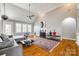 Open-concept living room with vaulted ceiling, fireplace, hardwood floors, and modern decor at 1126 Blowing Rock Cv, Fort Mill, SC 29708