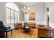 Sitting area with a piano, leather furniture, hardwood flooring, and a chandelier at 1126 Blowing Rock Cv, Fort Mill, SC 29708