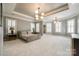 Spacious main bedroom with a tray ceiling, carpet, multiple windows, and recessed lighting at 1126 Blowing Rock Cv, Fort Mill, SC 29708