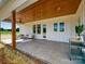Inviting back porch with wood ceiling and white columns offering an outdoor lounging area with seating and backyard views at 1160 Springlake Rd, York, SC 29745
